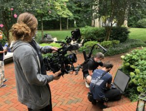 Sienna Twiss holding a camera during a day of production.