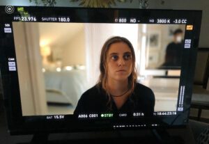 Siena Twiss, an intern at JTWO, seen on a film set through a monitor.