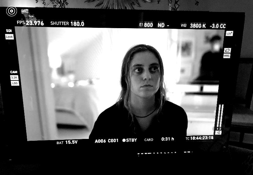 Siena Twiss, an intern at JTWO, seen on a film set through a monitor.